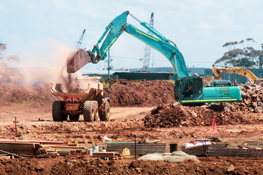 Large scale construction site with excavator and dump truck - active construction project for one time close construction loans in Columbus Ohio